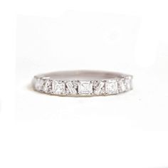 a white gold wedding band with princess cut diamonds