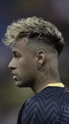 a close up of a person with a tattoo on his neck and hair in a mohawk