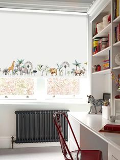 a room with a desk, chair and bookcases in front of a window