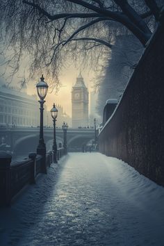 a snowy street with a lamp post and big ben in the background