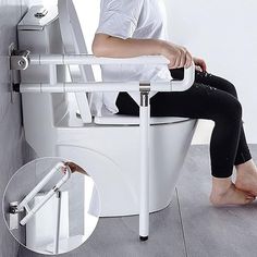 a person sitting on top of a toilet with their legs up and the seat down