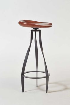 the backless bar stool has a wooden seat