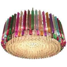 a multicolored chandelier hanging from the ceiling with many lights on it