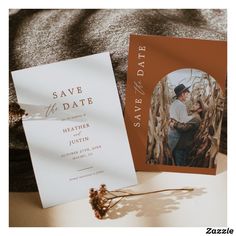 a wedding save the date card next to an envelope with a photo on it and a dried flower