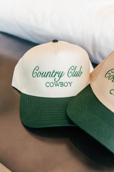 Calling all cowgirls! Elevate your style with our Country Club Cowboy Trucker Hat. Featuring an embroidered western graphic, this trendy hat is the perfect accessory to complete any casual outfit. Perfect for spring and summer, wear it to concerts and festivals for a chic and fashionable look. Will Ship 7/10! Twill cap Made in USA Embroidery at front and side panel Adjustable back strap Brim measures approx 3" in lengthOS measures approx 23.55" in circumference Country Style Flat Brim Baseball Cap For Rodeo, Country Style Snapback Hat For Rodeo With Flat Brim, Western Flat Brim Baseball Cap For Rodeo, Country Style Flat Brim Snapback Hat For Rodeo, Country Style Baseball Cap For Western-themed Events, Country Style Baseball Cap For Western Events, Western Style Baseball Cap With Curved Brim For Rodeo, Western Style Snapback Baseball Cap For Country Events, Western Style Curved Brim Baseball Cap For Rodeo