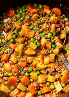 a pot filled with peas, carrots and ground beef