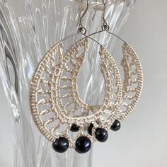 Adorable shimmering white crochet earrings, made of satin viscose silk thread. These beaded hoop earrings have thee black pearls dangling beautifully around your neck. Unique piece of jewelry that will make you shine. These elegant cocktail party earrings are ideal accessory for special occasions like evening parties, weddings, cocktails and other special events. Perfect gift for your wife or girlfriend for Valentine's day or birthdays.   Size Approx 3" / 7.5 cm long 2 " / 5 cm wide Color white Silk Crochet, Large Drop Earrings, Elegant Crochet, Earrings Big, Party Earrings, Beaded Hoop Earrings, White Crochet, Black Pearl, Crocheted Item