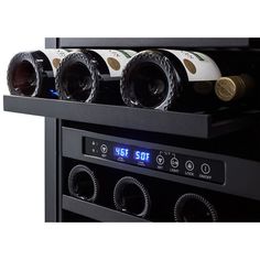 several bottles of wine are stacked on top of each other in a black rack with timers