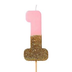 a pink and gold number one candle on a stick