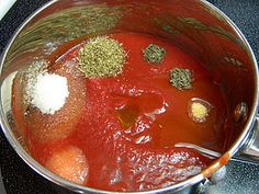 a pot filled with soup and spices on top of a stove