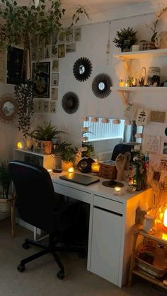 a desk with some plants and candles on it