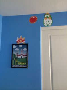 a room with blue walls and an image of mario bros on the wall next to it