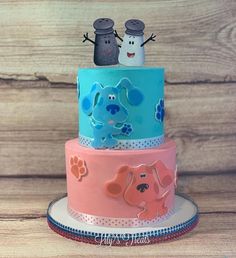 three tiered cake decorated with dogs and snowmen