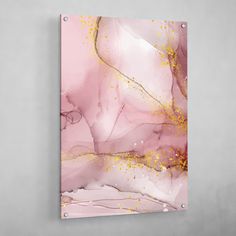 a pink and gold abstract painting on canvas with white wall behind it that has yellow sprinkles