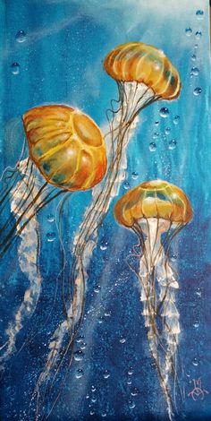 three yellow jellyfish floating in the water on a blue background with drops of water