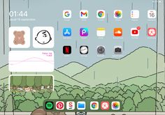 an ipad with icons on the screen and in the background there is a drawing of a bear