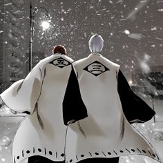 two people standing in the snow with their backs to each other