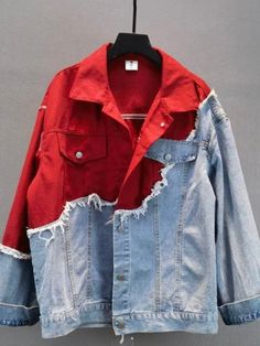 a red and blue jean jacket hanging on a clothes hanger with two holes in it