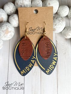 "Genuine Leather Earrings handmade with an embossed football. Genuine Navy Blue Leather with \"Midway\" heat pressed on in gold. S P E C I F I C A T I O N S - Earrings are approximately 3.25\" long and about 1.375\" wide - Ear wire is gold-plated - Each pair comes with 2 rubber earring backs This listing is for one (1) pair of genuine leather layered earrings. **Please note that color may be slightly different due to monitor displays and pattern may be different due to the nature of the cut on the pattern. All earrings are made to order with care, so slight variations may also occur from photo.**" Diy Football Earrings, Football Earrings Cricut, Leather Football Earrings, Sports Earrings, Laser Crafts, Cricut Earrings, Football Jewelry, Diy En Cuir, Layered Earrings