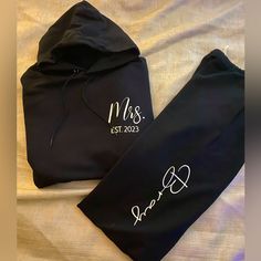 two personalized sweatshirts on a bed with the name mr and mrs written on them