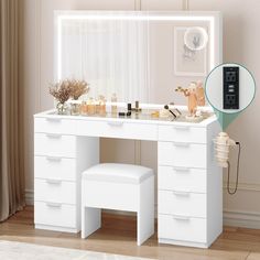 a white dressing table with drawers and stools in front of a mirror that has lights on it