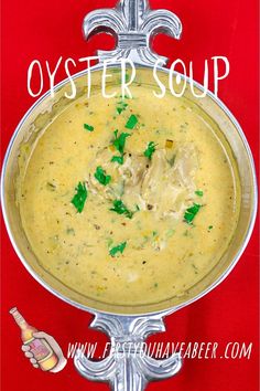 a metal bowl filled with soup on top of a red tablecloth and the words oyster soup above it