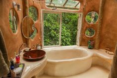 a bathroom with a large tub next to a window