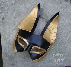 a black and gold mask laying on the ground