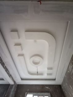 the ceiling is covered in white paint and has no light fixture on it, as well as an open window