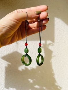 A simple handmade phone charm made of green jade ring, combining with an irregular-shape bead and an agate bead. Knowledge about Jade behind the scenes: Jade is often revered for its beautiful green hues and its symbolic significance of purity, tranquility, and protection. It is a cherished symbol of tradition, elegance, and positive energy in Chinese culture. Green Jade Ring, Phone Plug, Holder Phone, Green Hues, Jade Ring, Green Jade, Chinese Culture, Phone Charm, Agate Beads