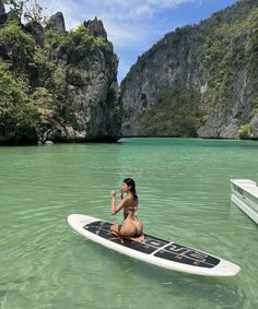 a woman sitting on top of a surfboard in the ocean