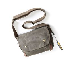 The Men's Canvas Shoulder Bag is a stylish choice for men who are looking for a practical and masculine bag. Made of sturdy canvas with a vintage look, this bag is built to last! A Small Waxed Canvas Crossbody Bag ideal for your travels The men's canvas shoulder bag has a very masculine look with its sleek and stylish design. The flap with snap adds a touch of sophistication to your outfit. The choice of canvas as the material of manufacture adds a vintage touch that will appeal to retro style l Khaki Shoulder Bag For Everyday Use, Classic Outdoor Shoulder Bag With Waxed Finish, Classic Waxed Canvas Shoulder Bag For Outdoor, Classic Outdoor Waxed Canvas Shoulder Bag, Classic Waxed Finish Shoulder Bag For Outdoor, Vintage Shoulder Bag With Adjustable Strap For Adventure, Functional Waxed Canvas Adventure Bag, Rugged Travel Crossbody Bag, Brown Waxed Canvas Shoulder Bag For Outdoor Activities