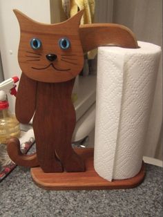 a toilet paper holder made to look like a cat