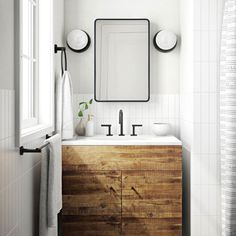 a bathroom with a sink, mirror and towel on the rack in front of it