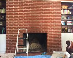 a living room with a fire place and bookshelves