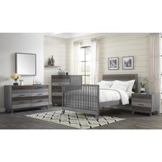 a baby's room with a crib, dresser and bed in grey tones