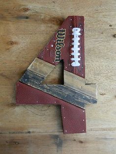 a wooden letter shaped like a football with the number 4 on it's side