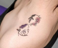 a woman's breast with flowers and leaves on her left side, tattoo style