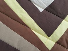 a close up view of a piece of fabric with different colors and shapes on it