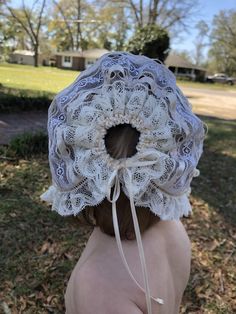 This delicate bonnet is made completely of lace strips sewn together. Ribbons tie at back and under chin. Perfect for any occasion! Measure from bottom of earlobe over the top of head to bottom of earlobe Note: 2 different bonnets are depicted. Laces may vary due to availability Adjustable Lace Wedding Bonnet, White Adjustable Lace Bonnet, White Lace Adjustable Bonnet, Fitted Cream Bonnet With Lace Trim, Adjustable Ruffled Bonnet, Blessing Gown, Lace Bonnet, Baby Blessing, Easter Sunday