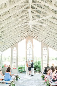 a bride and groom standing at the alter during their wedding ceremony