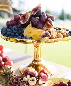 a platter filled with fruit on top of a table