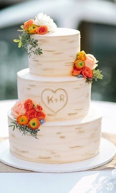 a white wedding cake with flowers on top