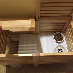 a person holding a bowl with food in it next to a wooden table and bench