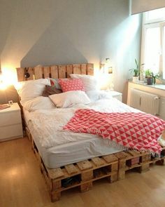 a bed made out of wooden pallets in a bedroom