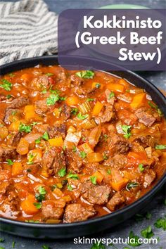 a bowl filled with beef stew and garnished with parsley on the side