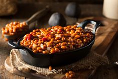 a pan filled with beans sitting on top of a wooden table