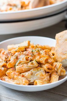 a bowl filled with pasta and bread on top of a table