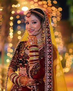 a woman in a red and yellow bridal outfit