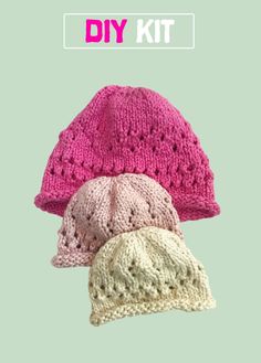 three knitted hats with the words diy kit written in pink, white and green